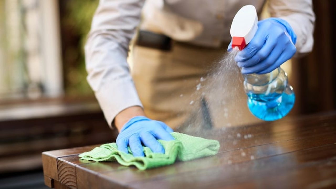 closeup-waitress-disinfecting-tables-outdoor-cafe_637285-7996