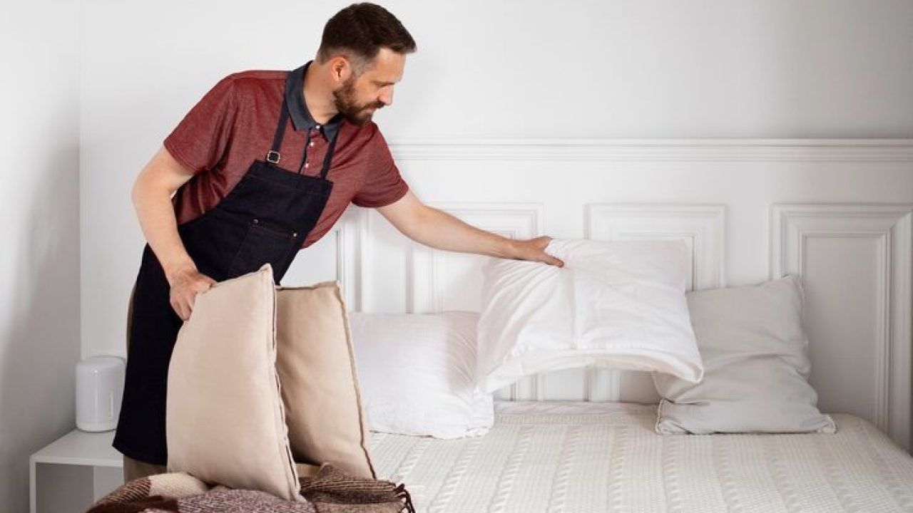 man-servant-making-bed_23-2149530831